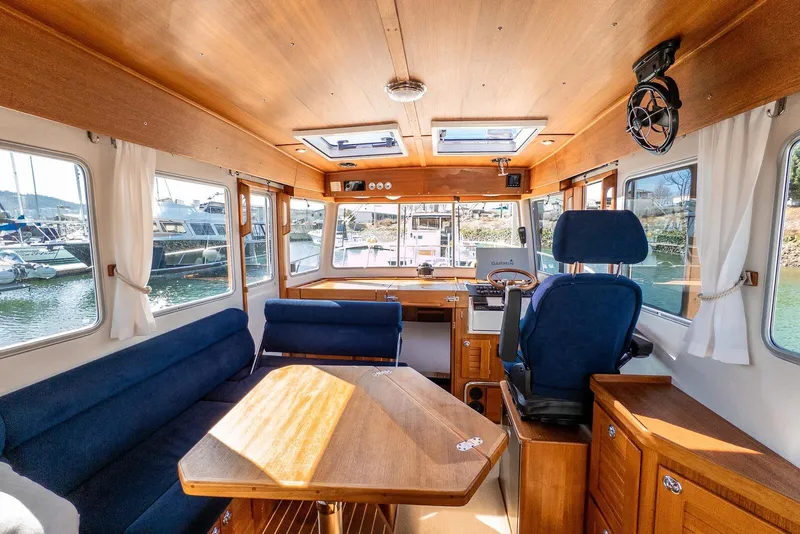 Slide: The Image of Interior of 2019 Targa 32 boat with wooden furnishings and blue seating. - 20