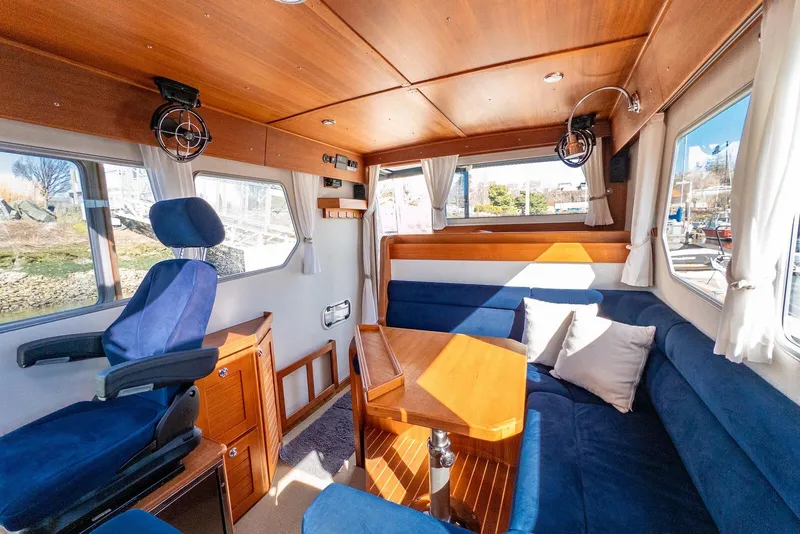 Slide: The Image of Interior of a 2019 Targa 32 boat with blue seating and wooden accents. - 21