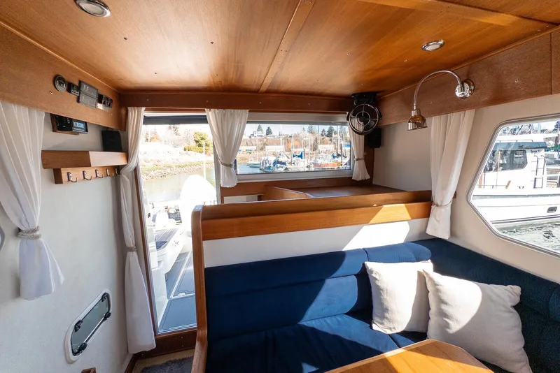 Slide: The Image of Interior of 2019 Targa 32 boat with wooden finish and blue seating. - 22