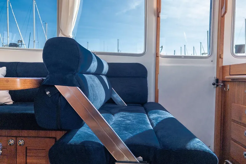 Slide: The Image of Interior of 2019 Targa 32 boat with blue seating and wooden accents. - 24