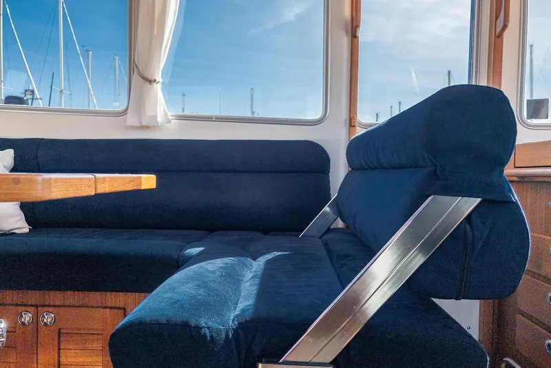 Slide: The Image of Interior of 2019 Targa 32 boat with blue seating and wooden table. - 25