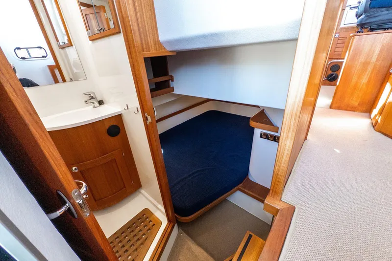 Slide: The Image of Interior of 2019 Targa 32 boat featuring a compact cabin and bathroom. - 26