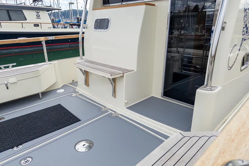 Slide: The Image of 2019 Targa 32 boat deck with seating and railing in marina setting. - 5