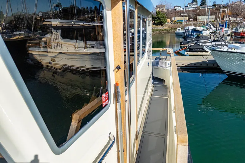 Slide: The Image of 2019 Targa 32 boat docked at marina, reflecting water and nearby vessels. - 9