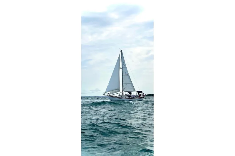 The Image of Sailboat on open sea, Shannon 28 model, 1988, under cloudy sky. - 0