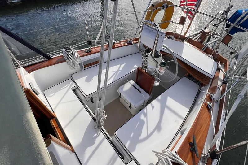 Slide: The Image of Cockpit of 1988 Shannon 28 sailboat with wooden trim and nautical equipment. - 14