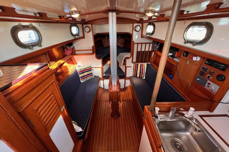 Slide: The Image of Interior of a 1988 Shannon 28 sailboat with wood finishes and cozy seating. - 3