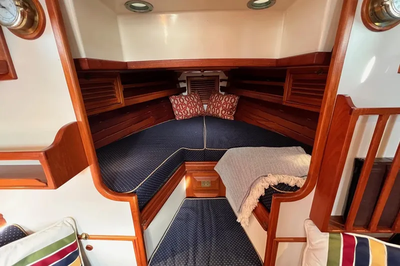 Slide: The Image of Cozy cabin interior of 1988 Shannon 28 sailboat with wooden accents and nautical decor. - 4