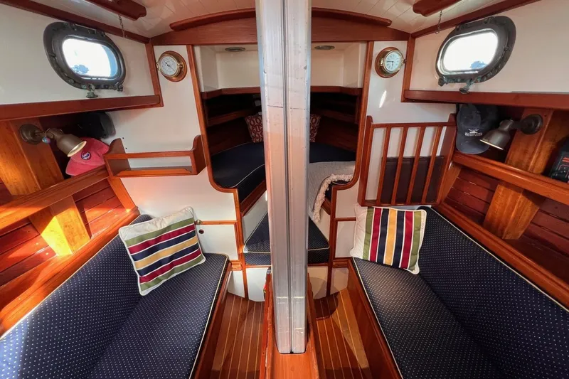 Slide: The Image of Interior of a 1988 Shannon 28 sailboat with cozy seating and nautical decor. - 7