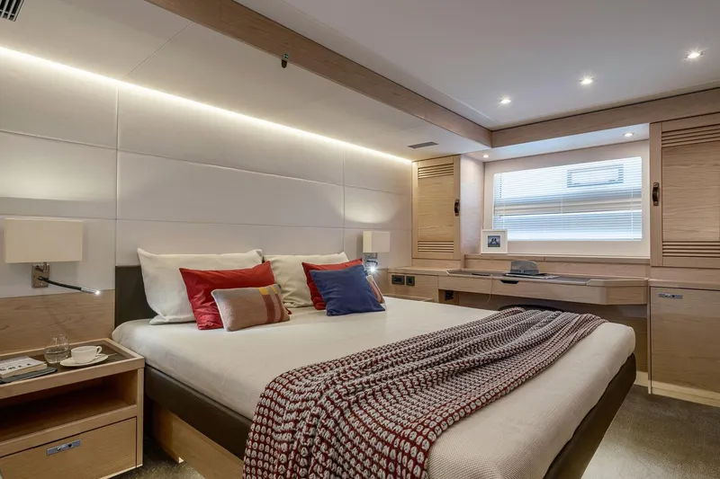 Slide: The Image of Luxurious bedroom interior of 2025 Beneteau Grand Trawler 63 yacht, featuring modern design and cozy decor. - 10