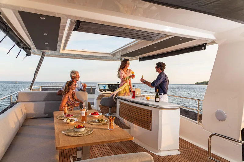 Slide: The Image of People enjoying drinks on a 2025 Beneteau Grand Trawler 63 yacht. - 28