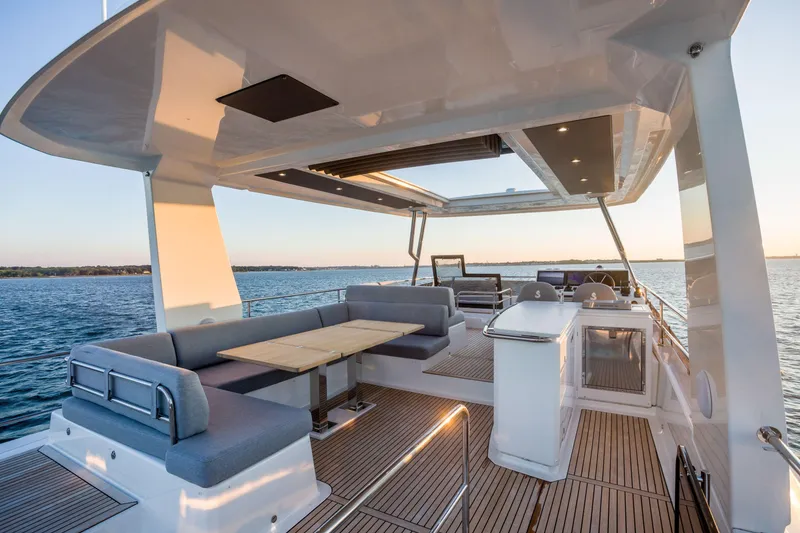Slide: The Image of Luxurious 2025 Beneteau Grand Trawler 63 yacht deck with seating and ocean view. - 32