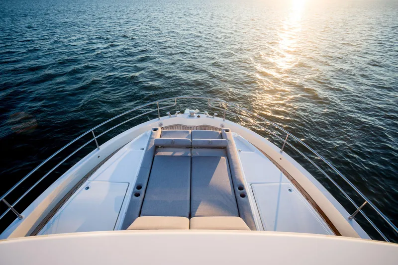 Slide: The Image of 2025 Beneteau Grand Trawler 63 bow view at sunset on open water. - 34