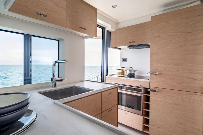 Slide: The Image of Modern kitchen interior on 2025 Beneteau Grand Trawler 63 yacht with ocean view. - 17