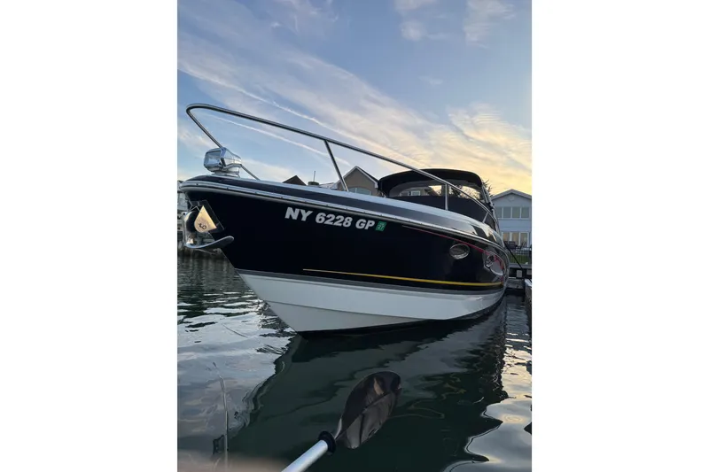 Slide: The Image of 2007 Formula 310 Sun Sport boat docked at sunset, reflecting on calm water. - 1