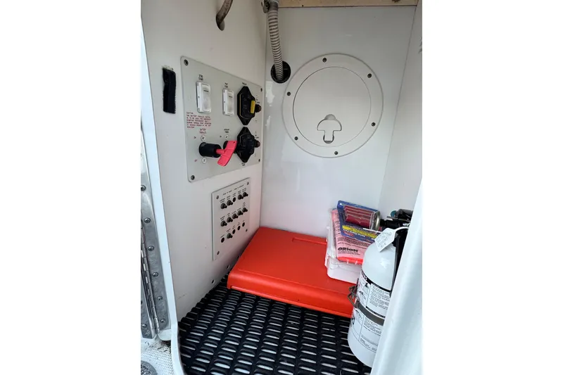 Slide: The Image of 2007 Formula 310 Sun Sport boat storage with safety equipment and control panel. - 15