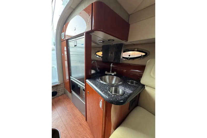 Slide: The Image of 2007 Formula 310 Sun Sport interior with kitchenette, sink, and wood cabinetry. - 18