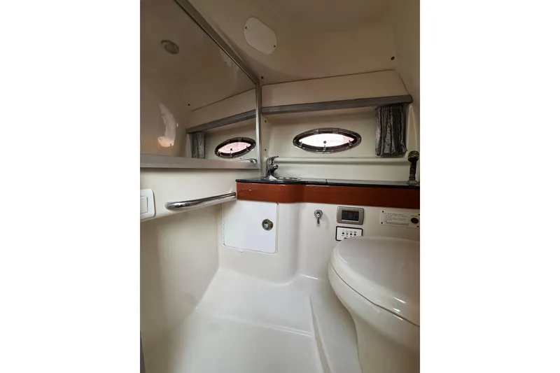 Slide: The Image of 2007 Formula 310 Sun Sport boat bathroom interior with sink and porthole window. - 19