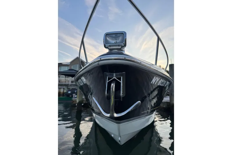 Slide: The Image of 2007 Formula 310 Sun Sport boat docked, front view with clear sky background. - 2