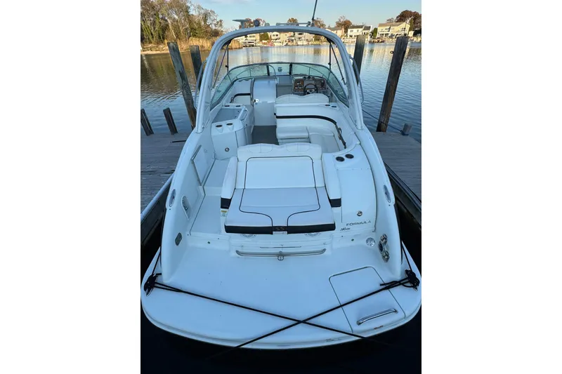 Slide: The Image of 2007 Formula 310 Sun Sport boat docked, featuring sleek white design and spacious seating. - 3