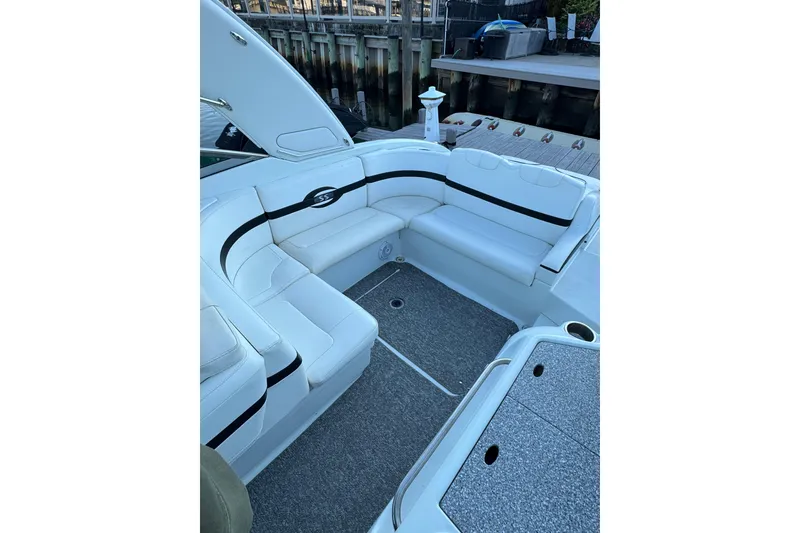 Slide: The Image of 2007 Formula 310 Sun Sport boat interior with white seating and dock view. - 6