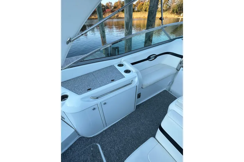 Slide: The Image of 2007 Formula 310 Sun Sport boat interior with seating and storage, dockside view. - 8