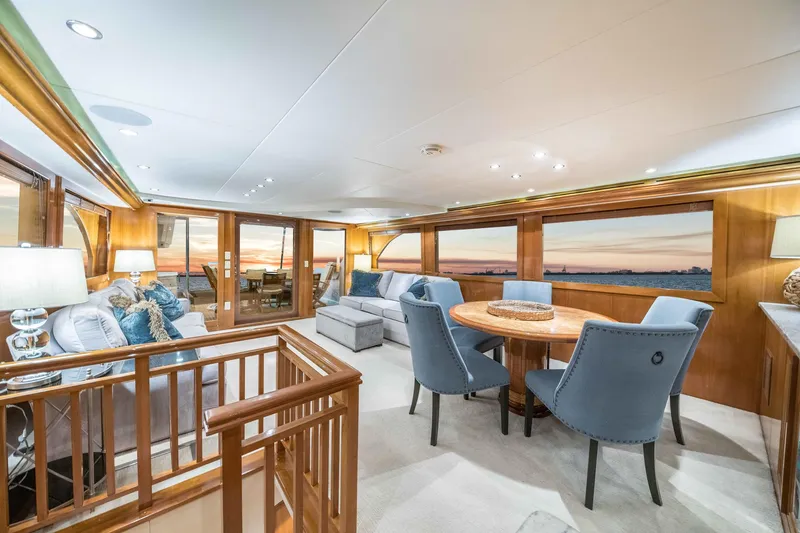 Slide: The Image of Luxurious 2002 Hatteras Motor Yacht interior with elegant seating and sunset views. - 27