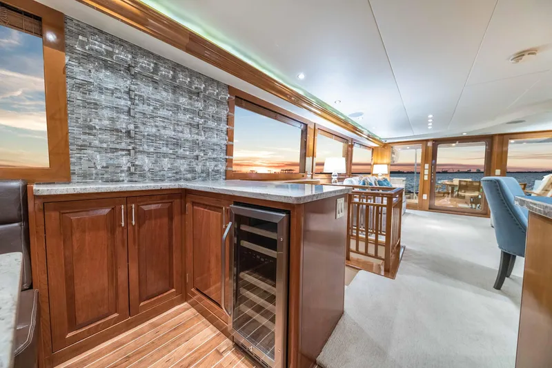 Slide: The Image of Luxurious interior of a 2002 Hatteras Motor Yacht with elegant wood cabinetry and sunset views. - 29