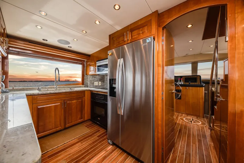 Slide: The Image of Luxurious kitchen interior of 2002 Hatteras Motor Yacht with sunset view. - 30