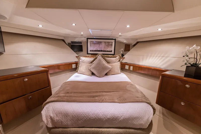Slide: The Image of Luxurious bedroom interior of a 2002 Hatteras Motor Yacht with elegant wood finishes. - 34