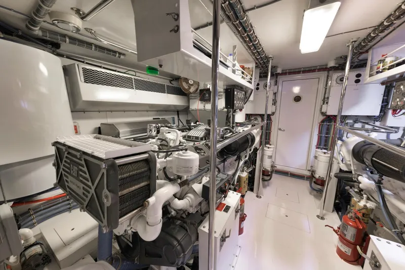 Slide: The Image of Engine room of a 2002 Hatteras Motor Yacht, featuring complex machinery and equipment. - 41