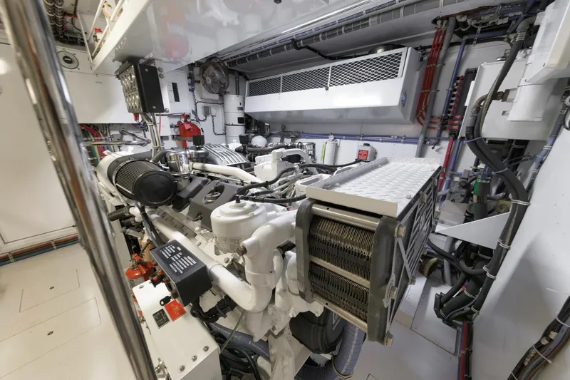 Slide: The Image of Engine room of a 2002 Hatteras Motor Yacht, showcasing complex machinery and components. - 42