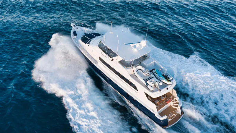 Slide: The Image of 2002 Hatteras Motor Yacht cruising on open water, aerial view. - 6