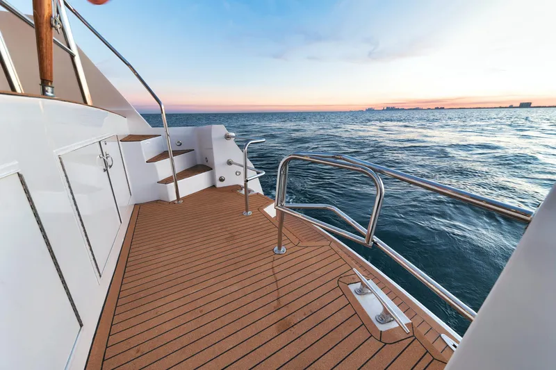 Slide: The Image of Hatteras 2002 Motor Yacht deck with ocean view at sunset. - 20
