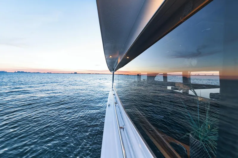 Slide: The Image of 2002 Hatteras Motor Yacht cruising on calm ocean at sunset. - 23