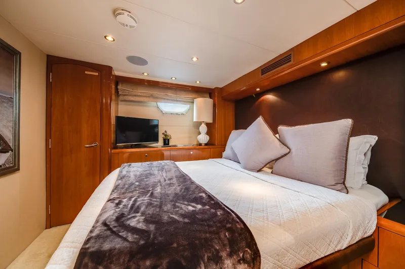 Slide: The Image of Luxurious bedroom interior of 2002 Hatteras Motor Yacht with cozy bedding and elegant wood finishes. - 33