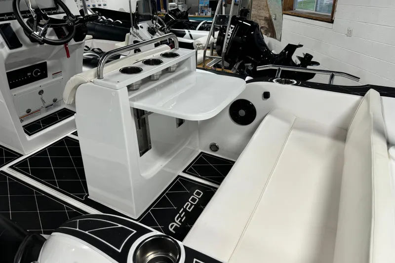 Slide: The Image of 2023 Aquaform 200 AF boat interior with seating, cup holders, and control panel. - 4