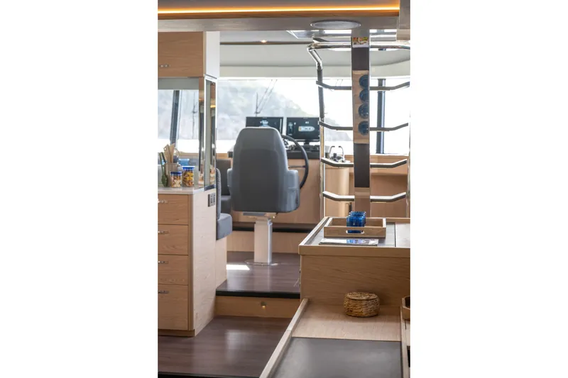 Slide: The Image of Interior of 2026 Beneteau Swift Trawler 54, featuring modern helm and wooden cabinetry. - 11