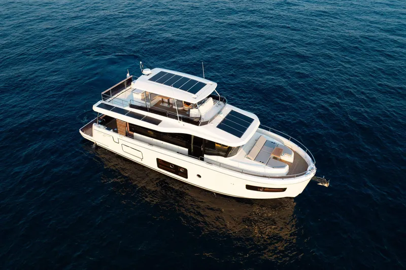 Slide: The Image of 2026 Beneteau Swift Trawler 54 cruising on open sea, aerial view. - 21