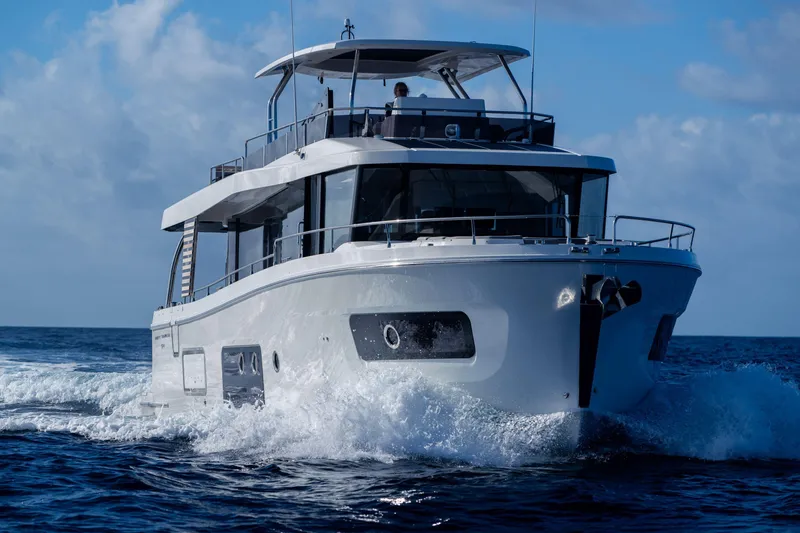 Slide: The Image of 2026 Beneteau Swift Trawler 54 cruising on open water, showcasing sleek design and performance. - 28