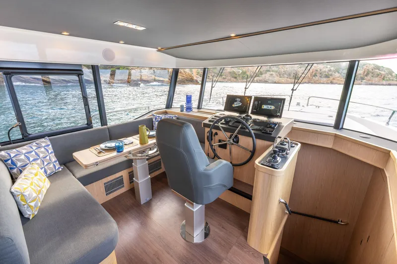 Slide: The Image of Interior of 2026 Beneteau Swift Trawler 54, featuring modern helm and seating area. - 34
