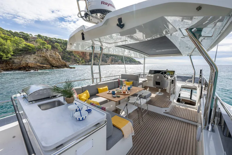 Slide: The Image of Luxurious 2026 Beneteau Swift Trawler 54 yacht interior with dining area and ocean view. - 41