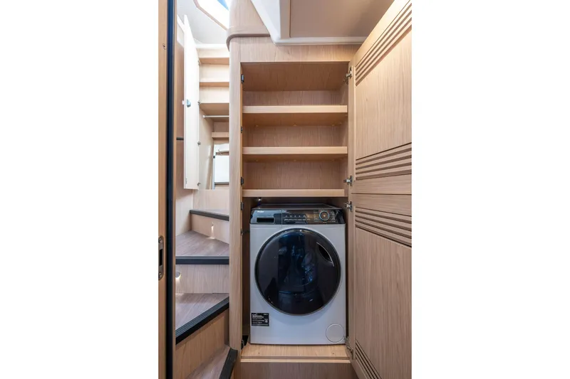 Slide: The Image of Laundry area with washer in 2026 Beneteau Swift Trawler 54 yacht. - 43