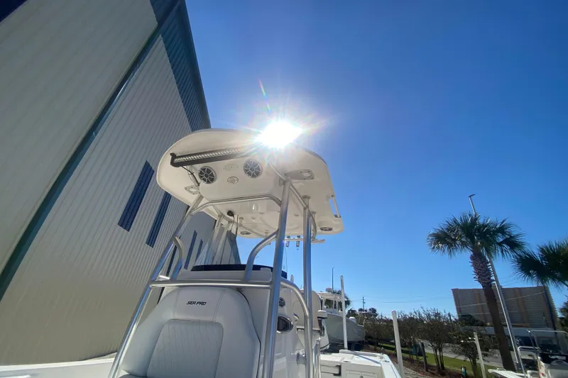 Slide: The Image of 2021 Sea Pro 248 Bay boat under clear blue sky with palm trees. - 10