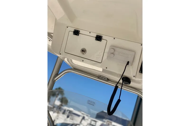 Slide: The Image of 2021 Sea Pro 248 Bay boat console with Simrad electronics and storage compartment. - 12