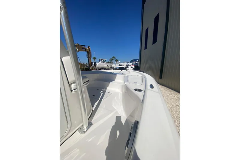 Slide: The Image of 2021 Sea Pro 248 Bay boat docked beside a building under clear blue sky. - 14