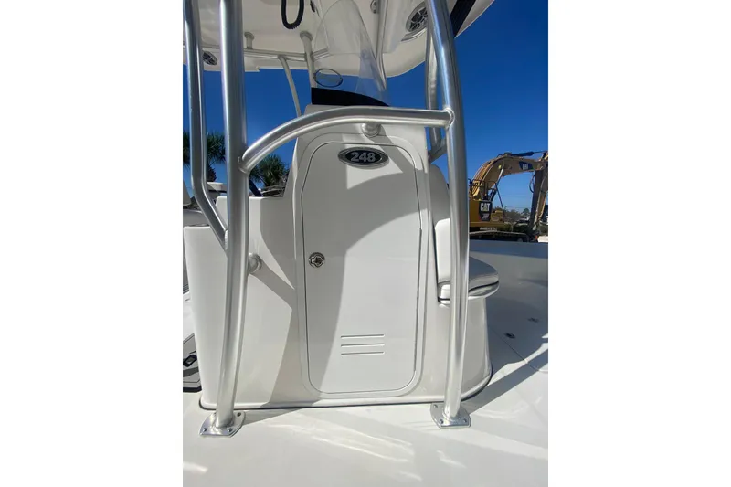 Slide: The Image of 2021 Sea Pro 248 Bay boat console with stainless steel frame under clear blue sky. - 15