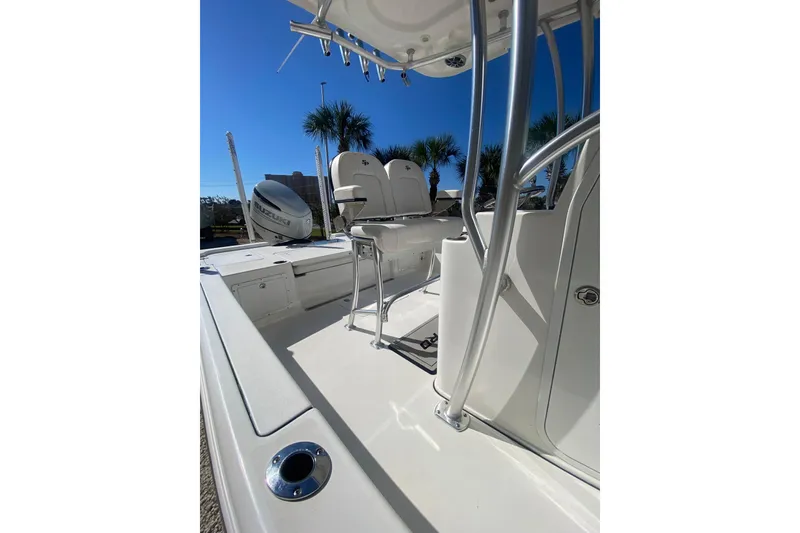 Slide: The Image of 2021 Sea Pro 248 Bay boat deck with seating and Suzuki outboard motor. - 16