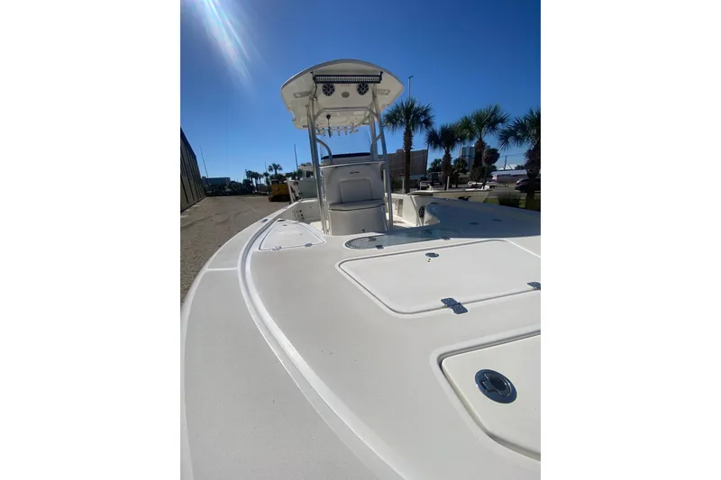 Slide: The Image of 2021 Sea Pro 248 Bay boat with T-top, docked under clear blue sky. - 17