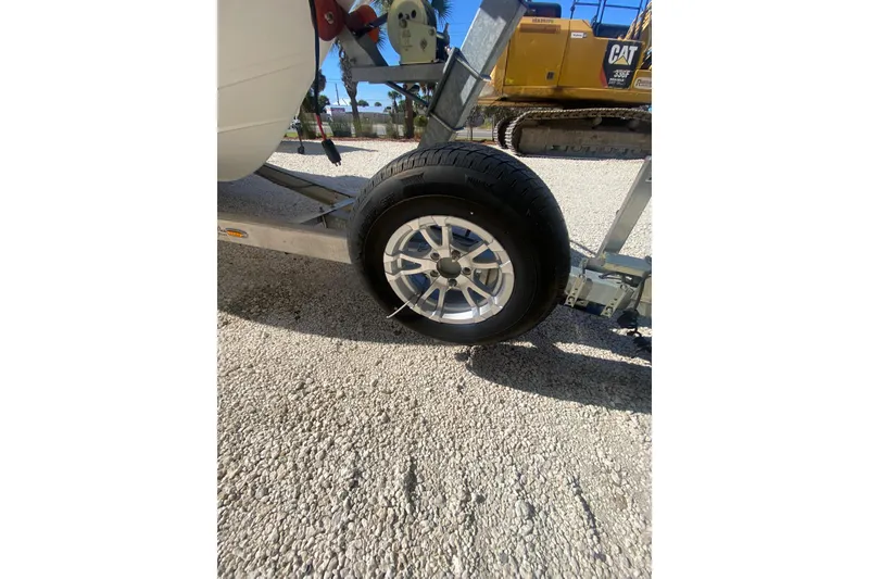 Slide: The Image of Trailer wheel of 2021 Sea Pro 248 Bay boat on gravel surface. - 18